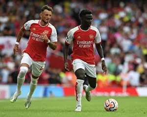 Arsenal's Saka and White in Action: Arsenal FC vs. Nottingham Forest, 2023-24 Premier League