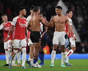 Arsenal's Saliba and Bade Exchange Shirts after Exciting Arsenal FC vs Sevilla FC UCL Clash, 2023-24