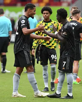 Arsenal's Saliba and Saka Celebrate Victory: Brentford FC vs Arsenal FC, Premier League 2022-23