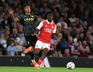 Arsenal's Sambi Outmaneuvers Aston Villa's Ollie Watkins in 2022-23 Premier League Clash