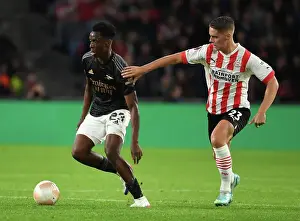 Arsenal's Sambi Outmaneuvers PSV's Veerman in Europa League Clash