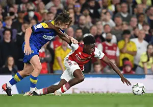 Arsenal's Sambi Outmaneuvers Wimbledon's Woodyard in Carabao Cup Clash