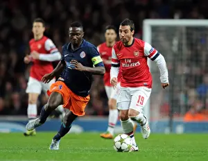 Arsenal V Montpellier 2012-13 Prints: Arsenal's Santi Cazorla Clashes with Montpellier's Mapou Yanga-Mbiwa in UEFA Champions League Showdown