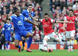 Arsenal V Everton - FA Cup 2014 Prints: Arsenal's Santi Cazorla Faces Off Against Everton's Sylvain Distin in FA Cup Quarter-Final Showdown