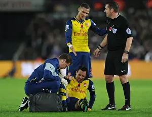 Swansea V Arsenal 2014-15 Prints: Arsenal's Santi Cazorla Receives Treatment from Physio Amid Swansea Tussle