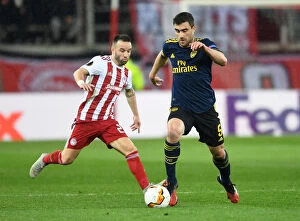 Olympiacos v Arsenal 2019-20 Collection: Arsenal's Sokratis Faces Off Against Valbuena in UEFA Europa League Showdown, Piraeus 2020