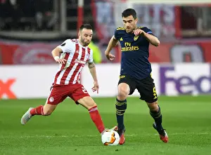 Olympiacos V Arsenal 2019-20 Prints: Arsenal's Sokratis Faces Off Against Valbuena in UEFA Europa League Showdown