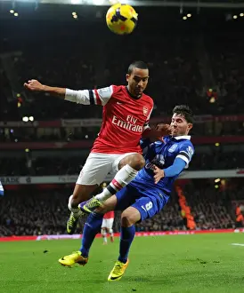 Arsenal V Everton 2013-14 Prints: Arsenal's Theo Walcott Faces Off Against Everton's Bryan Oviedo in Premier League Clash