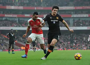 Arsenal's Theo Walcott Faces Off Against Hull's Harry Maguire in Premier League Clash