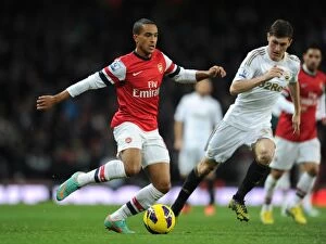 Arsenal v Swansea 2012-13 Collection: Arsenal's Theo Walcott Faces Off Against Swansea's Ben Davies in Premier League Clash (2012-13)