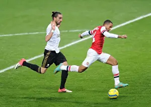 Arsenal V Swansea - FA Cup 3rd Rd Replay 2012-13 Prints: Arsenal's Theo Walcott Faces Off Against Swansea's Chico Flores in FA Cup Third Round Replay