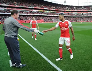 Arsenal V Swansea City 2016-17 Prints: Arsenal's Theo Walcott Hydrates with Physio Colin Lewin Before Arsenal v Swansea City (2016-17)