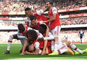 Arsenal V AFC Bournemouth 2019-20 Prints: Arsenal's Thrilling Team Goal: David Luiz Scores and Celebrates with Team against AFC Bournemouth (2019-20)