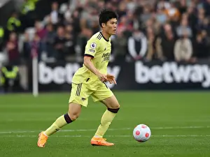 West Ham United V Arsenal 2021-22 Prints: Arsenal's Tomiyasu in Action against West Ham in Premier League Showdown