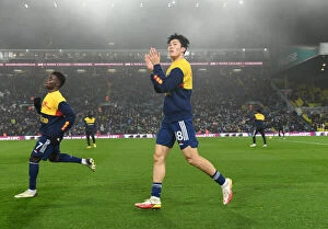 Images Dated 19th December 2021: Arsenal's Tomiyasu Applauding Fans: Leeds United vs Arsenal, Premier League 2021-22