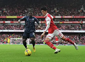 Arsenal V Nottingham Forest 2022-23 Prints: Arsenal's Tomiyasu Outruns Aurier in Premier League Clash vs. Nottingham Forest