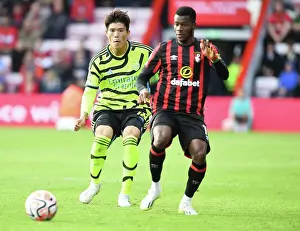Arsenal's Tomiyasu Pressures Ouattara in AFC Bournemouth Clash (2023-24 Premier League)