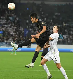FC Zurich V Arsenal 2022-23 Prints: Arsenal's Tomiyasu Soars Over Zurich's Selnaes in Europa League Clash