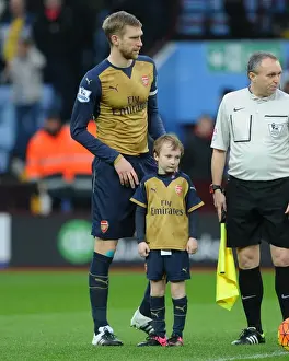 Arsenal's Triumph: Per Mertesacker and the Gunners Celebrate 2-0 Victory over Aston Villa at Villa Park (Premier League, December 13, 2015)