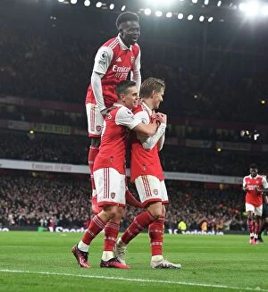 Arsenal v Everton 2022-23 Collection: Arsenal's Triumph: Odegaard, Trossard, and Saka Celebrate 3rd Goal vs. Everton (2022-23)