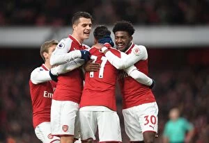 Images Dated 16th December 2017: Arsenal's Triumph: Ozil, Xhaka, Maitland-Niles in Unison - Goal Celebration (2017-18)