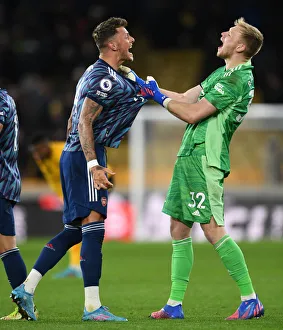 Arsenal's Triumphant Moment: Ben White and Aaron Ramsdale Celebrate Victory over Wolverhampton Wanderers in Premier League 2021-22