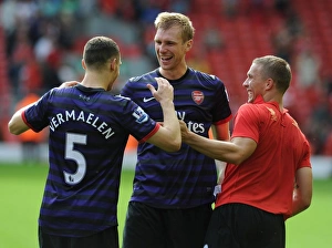 Arsenal's Triumphant Trio: Vermaelen, Mertesacker, Podolski Celebrate Victory at Anfield