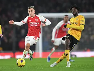 Arsenal's Trossard Chases Down Traore in Intense 2023-24 Premier League Showdown