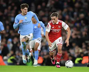 Manchester City V Arsenal 2022-23 Prints: Arsenal's Trossard Clashes with Man City's Stones in FA Cup Showdown