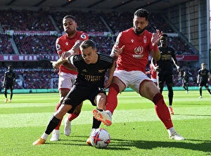 Images Dated 20th May 2023: Arsenal's Trossard Faces Off Against Forest's Lodi and Felipe in Intense Premier League Clash