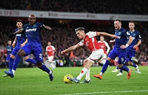 Arsenal v West Ham United 2023-24 Collection: Arsenal's Trossard Faces Off Against Ogbonna in Intense Premier League Clash (2023-24)