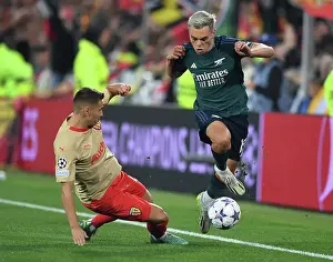 RC Lens V Arsenal 2023-24 Prints: Arsenal's Trossard Outmaneuvers RC Lens Frankowski in Champions League Clash