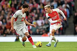 Arsenal's Trossard Outruns Sheffield United's Baldock in 2023-24 Premier League Clash