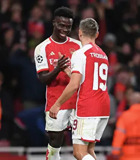 Arsenal's Trossard and Saka Celebrate First Goal Against Sevilla in 2023-24 UEFA Champions League