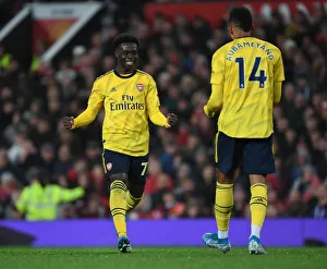 Manchester United V Arsenal 2019-20 Prints: Arsenal's Unforgettable Goal Celebration: Aubameyang and Saka's Strike Secures Victory Over Manchester United