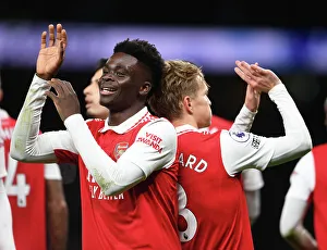 Arsenal's Unstoppable Duo: Martin Odegaard and Bukayo Saka Celebrate Goal Against Tottenham in the 2022-23 Premier League