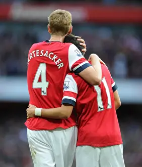 Arsenal V Norwich City 2013-14 Prints: Arsenal's Unstoppable Duo: Ozil and Mertesacker Celebrate Victory Over Norwich City