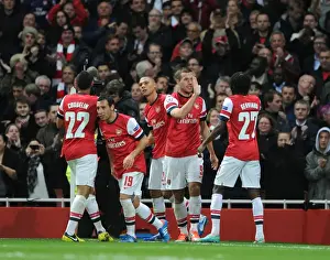 Arsenal's Unstoppable Duo: Podolski and Gervinho Celebrate 2-1 Over Olympiacos in Champions League