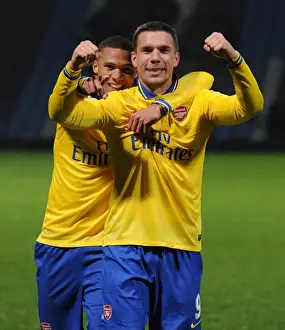 West Ham United V Arsenal 2013-14 Prints: Arsenal's Unstoppable Duo: Podolski and Gibbs Celebrate Victory over West Ham United