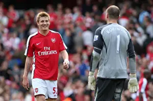 Arsenal's Victory: Bendtner Celebrates with Robinson after a 6-2 Thrashing of Blackburn