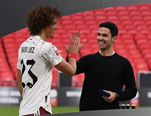 Arsenal's Victory Celebration: Mikel Arteta and David Luiz Embrace after FA Community Shield Win over Liverpool