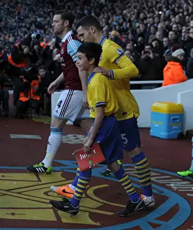 Arsenal's Victory: Thomas Vermaelen and the Arsenal Mascot Celebrate at The Boleyn Ground