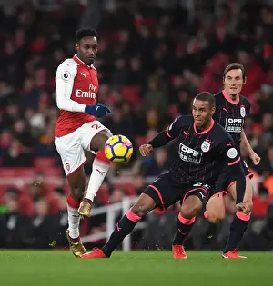 Arsenal's Welbeck Faces Off Against Huddersfield's Jorgensen in Premier League Clash