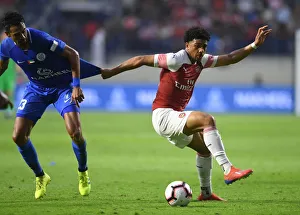 Al-Nasr Dubai SC V Arsenal 2018-19 Prints: Arsenal's Xavier Amaechi Faces Off Against Al-Nasr's JR. Dutra in Friendly Match