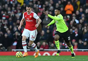 Arsenal's Xhaka Faces Pressure from Sheffield United's Mousset in Premier League Clash