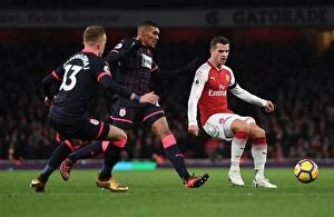 Images Dated 29th November 2017: Arsenal's Xhaka Fends Off Huddersfield Duo Welbeck, Hadergjonaj