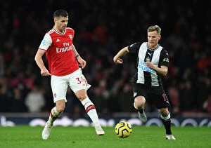 Arsenal v Newcastle United 2019-20 Collection: Arsenal's Xhaka Fends Off Newcastle's Ritchie During Premier League Clash