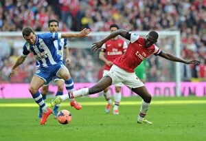 Images Dated 12th April 2014: Arsenal's Yaya Sanogo Faces Off Against Wigan's James McArthur in FA Cup Semi-Final Showdown