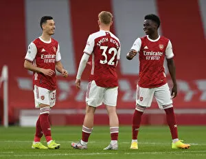 Images Dated 9th May 2021: Arsenal's Young Trio Unite: Behind-Closed-Doors Chat Amidst Empty Emirates Stadium
