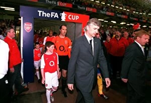 Arsene Wenger the Arsenal Manager leads to team out onto the pitch